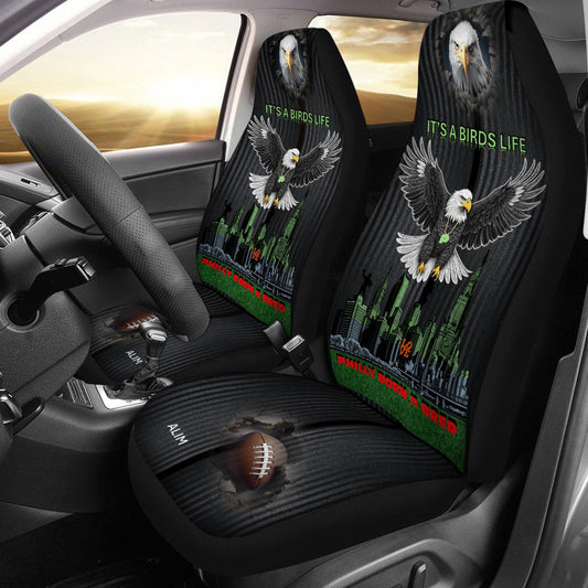 Car seat covers with eagle design and 'It's a Bird's Life' text inside a vehicle.