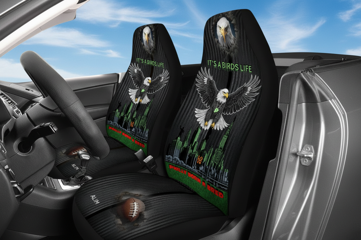 Car seat covers with eagle design and 'It's a Bird's Life' text inside a vehicle.