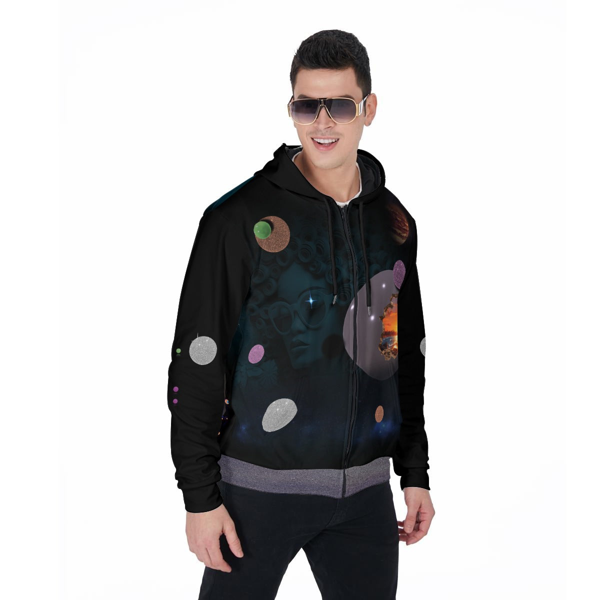 A man wearing a black zip-up hoodie with a colorful outer-space-themed graphic print, featuring planets, stars, and nebulae, set against a plain white background.