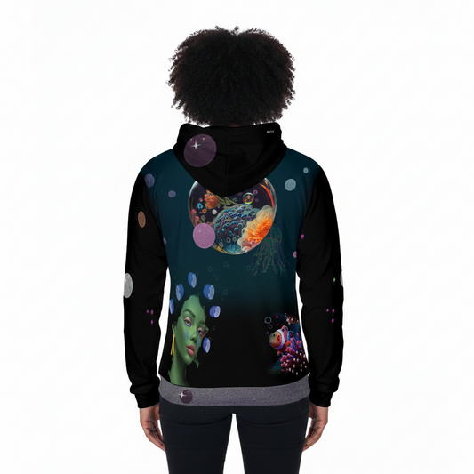 A person shown from the back wearing a black hoodie with a vivid cosmic and underwater-themed all-over print featuring a jellyfish, a fish, planets, and a green-skinned face on a dark teal background.