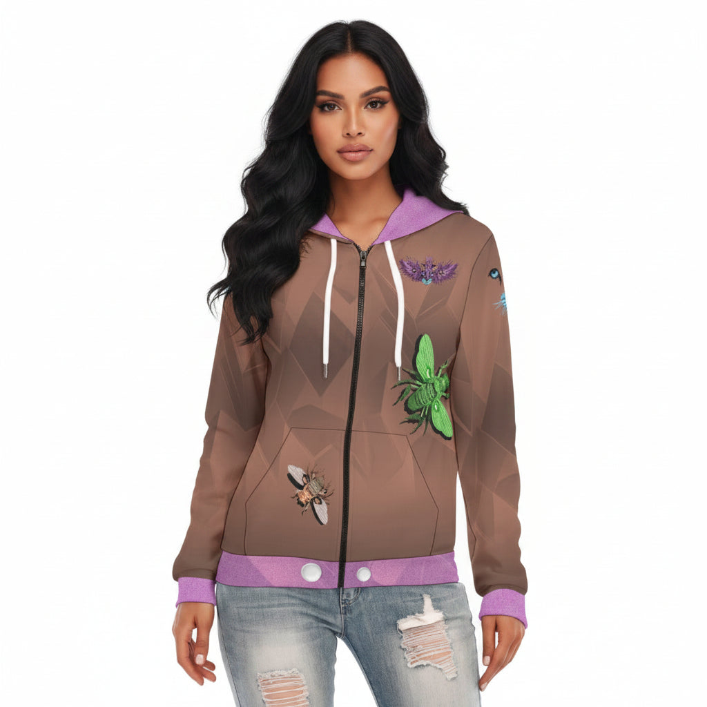 A woman modeling a brown zip-up hoodie with a geometric pattern, decorated with illustrations of insects like bees, butterflies, and a green beetle. The hoodie features a purple hood lining, white drawstrings, and a purple ribbed hem and cuffs, paired with distressed blue jeans against a plain white background.