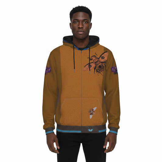 A man wearing a zip-up hoodie with a textured mustard-brown body, dark navy hood and cuffs, and graphic prints of bees on the chest and sleeve. The hoodie features a front pocket and ribbed hem and cuffs.